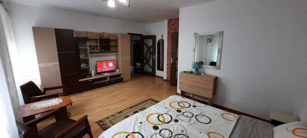 a living room with a dining table and a television at Ultracentral free private parking in Ploieşti