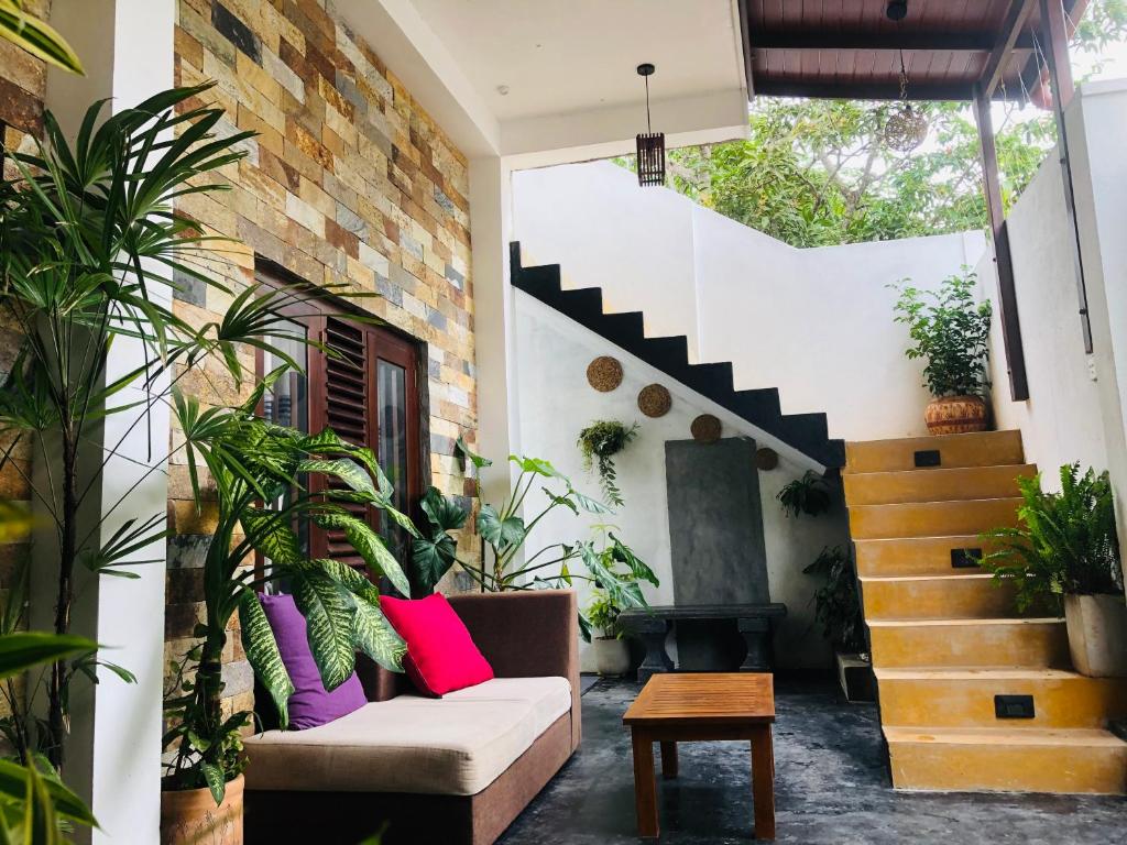 a living room with a couch and a staircase at Villa D40 in Weligama