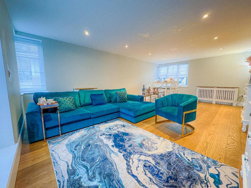 a living room with a blue couch and a table at My Richmond London SUPER KING Size Bed in Kew