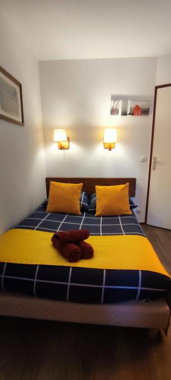 a bedroom with a bed with yellow and blue at Sympathique Appartement Le Chamois Blanc Chamonix, Parking in Chamonix