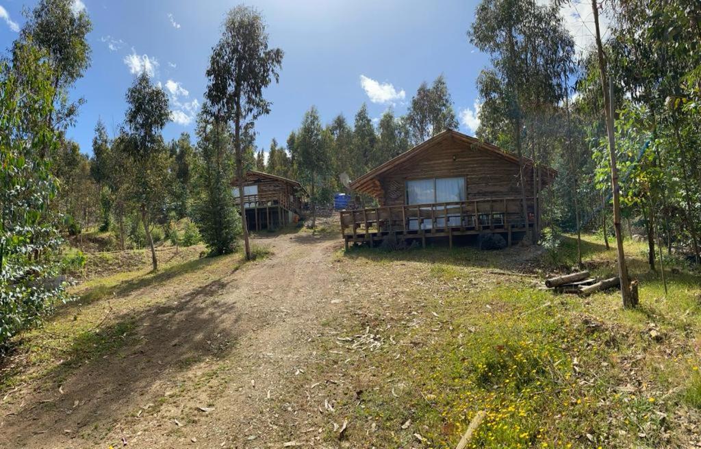 a cabin in the middle of a field with trees at Cabaña Don Pepe, en Estancia Don Domingo in Curicó