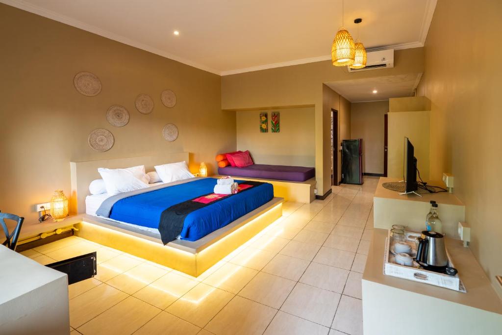 Jepun BnB Bali في سمينياك: غرفة نوم بسريرين وتلفزيون بشاشة مسطحة