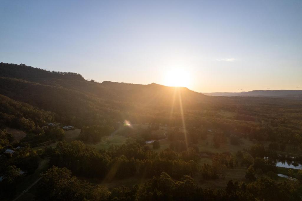 an aerial view of the sun setting on a mountain at Mike's Kangaroo Valley in Kangaroo Valley