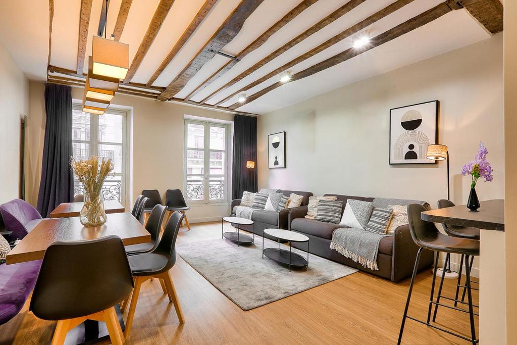 a living room with a couch and a table at Urban Flat 73 - Luxury Parisian Flat near Les Halles Rivoli in Paris