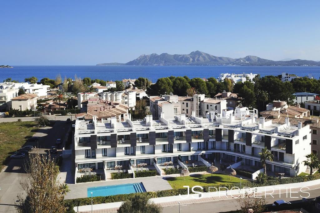 an aerial view of a large white building at Js Villas rental Ap La Perla 5 Puerto Pollensa in Port de Pollensa