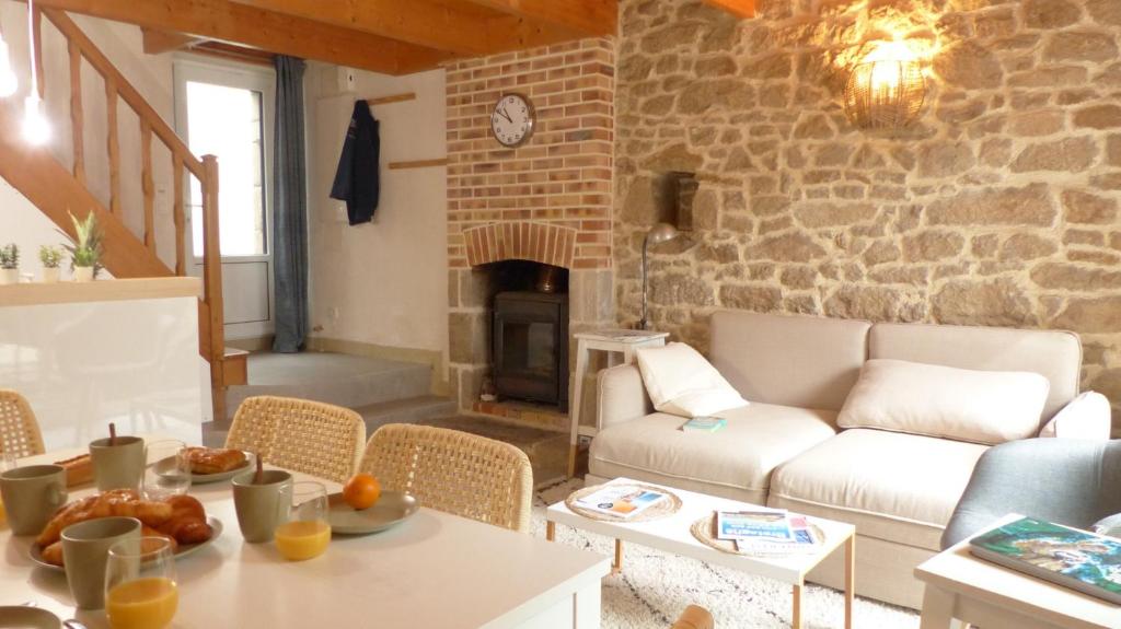 a living room with a couch and a table at Douillette maison de ville à Carnac in Carnac