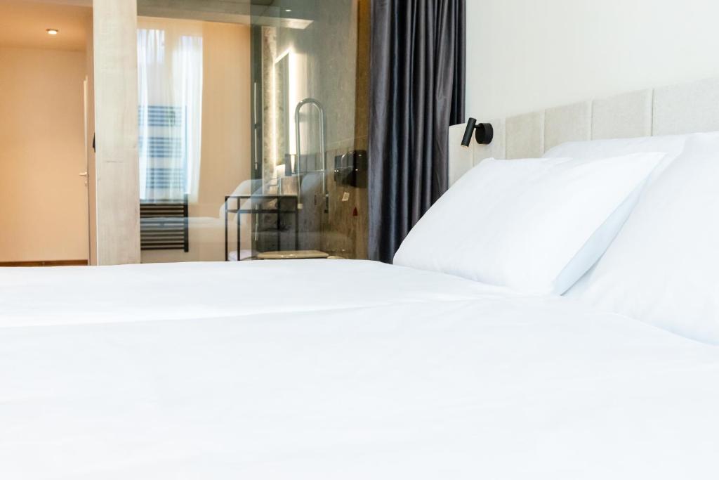Postel nebo postele na pokoji v ubytování Hotel Lonca