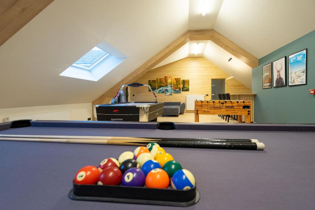 a room with a pool table with balls on it at Gîte DDS in Manhay