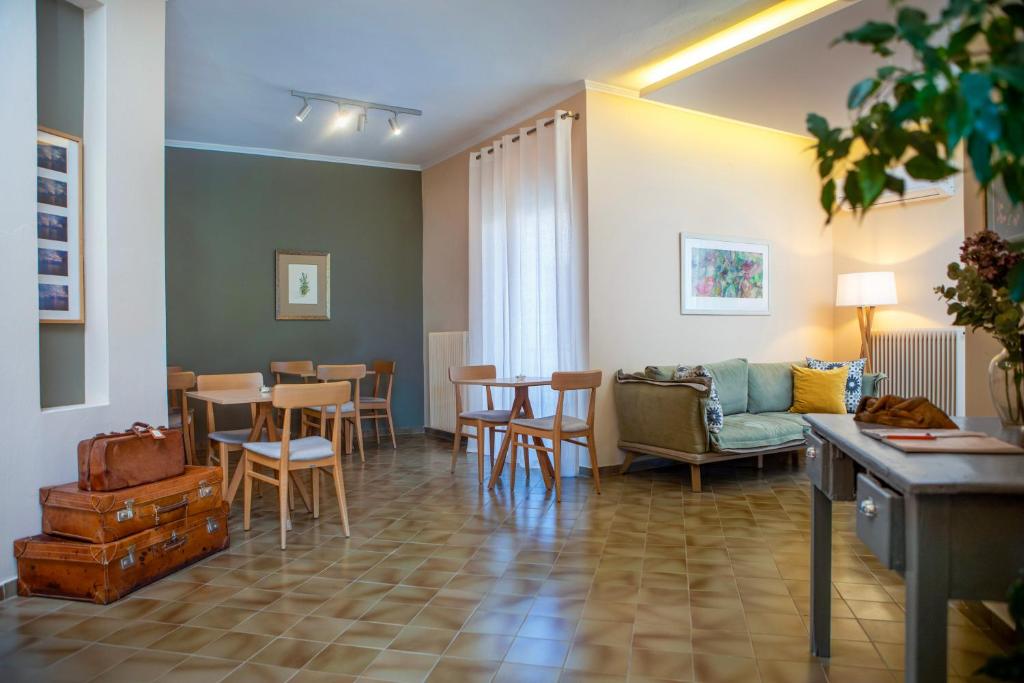 a living room with a couch and a table and chairs at Galini Hotel in Skala Eresou