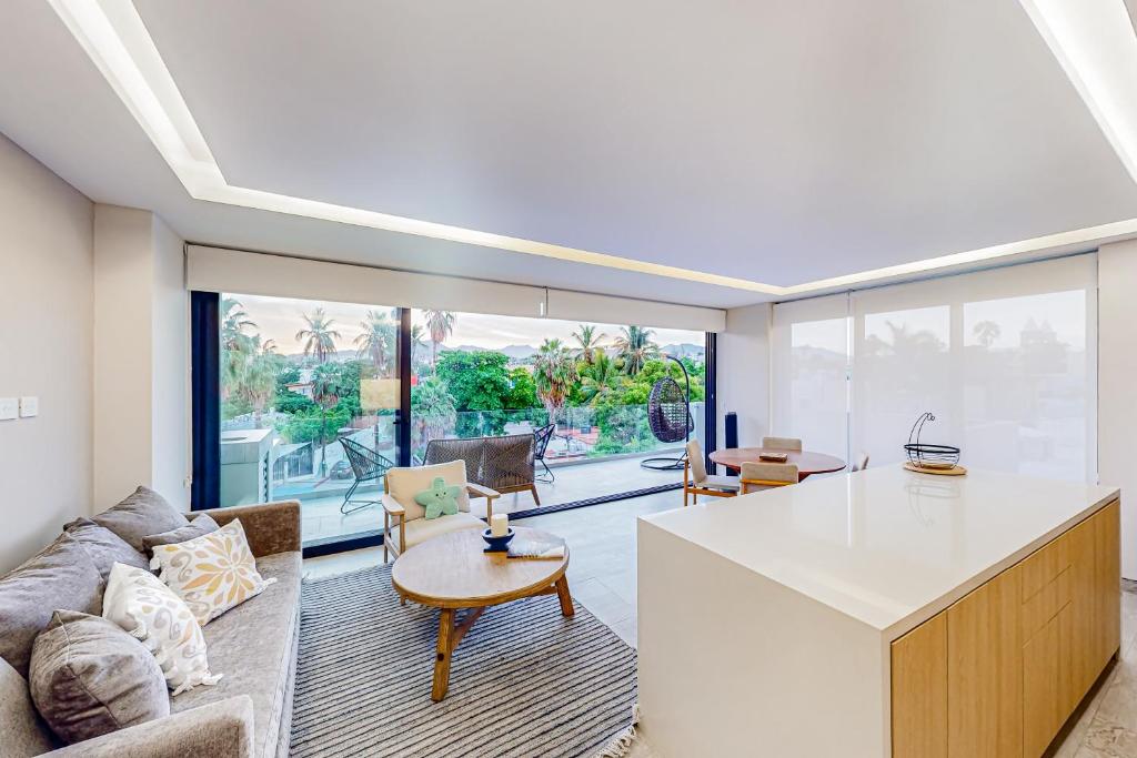 a kitchen and living room with a couch and a table at Cardinal Living San Jose del Cabo D-301 in San José del Cabo