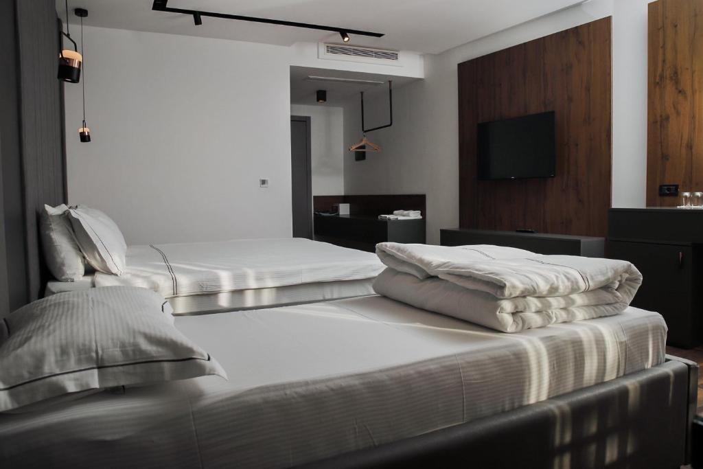 Postel nebo postele na pokoji v ubytování Triumf Hotel