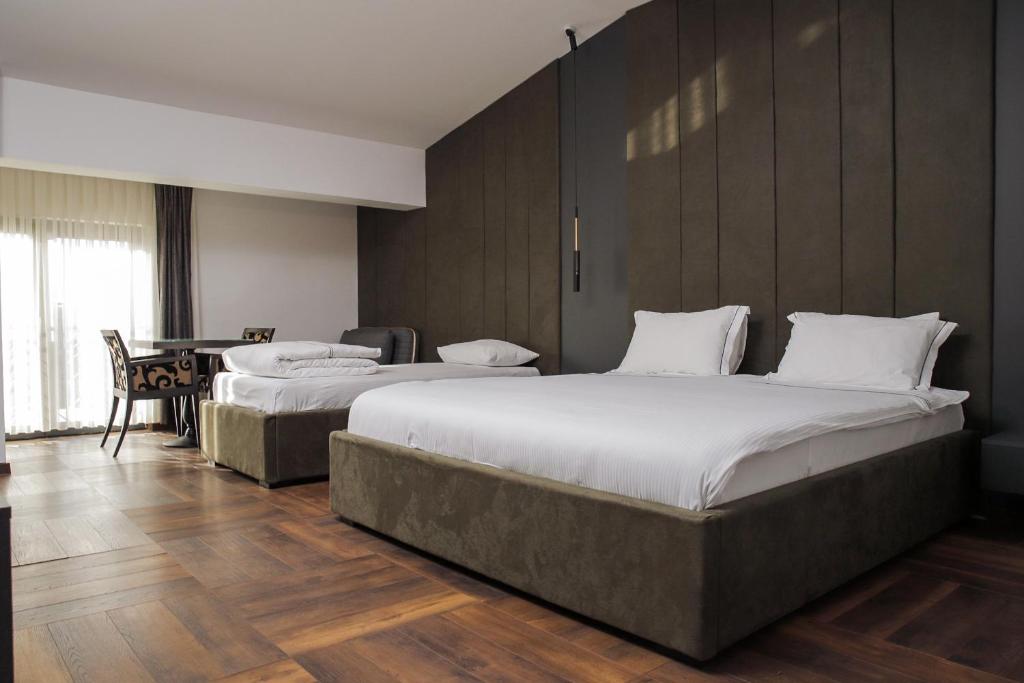 Postel nebo postele na pokoji v ubytování Triumf Hotel