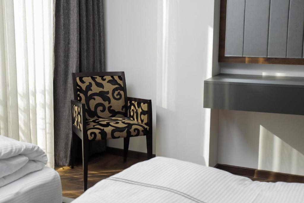 Postel nebo postele na pokoji v ubytování Triumf Hotel