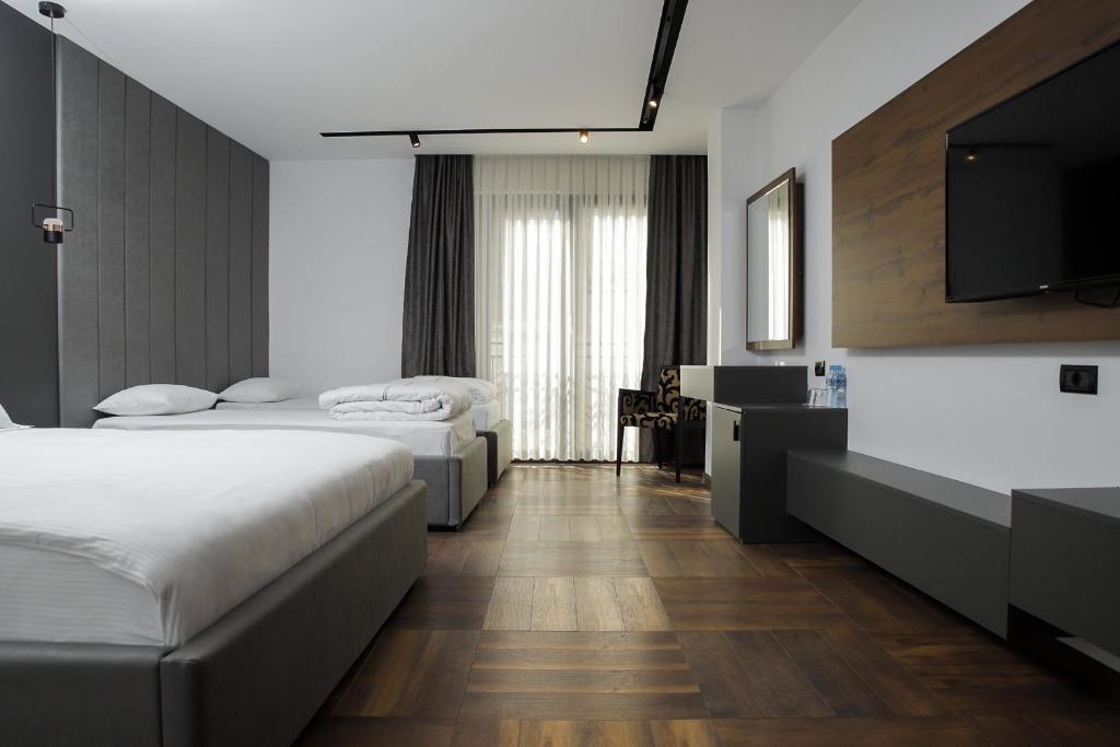 Postel nebo postele na pokoji v ubytování Triumf Hotel