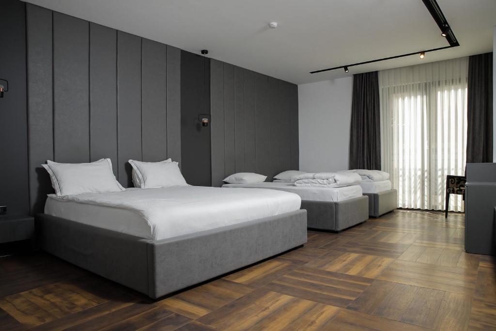 Postel nebo postele na pokoji v ubytování Triumf Hotel