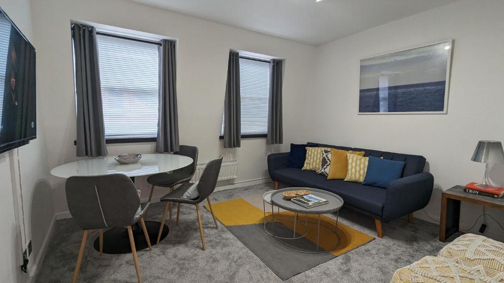 a living room with a couch and a table at Cozy Urban Oasis: Stylish One Bedroom Flat on Old Compton Street in London