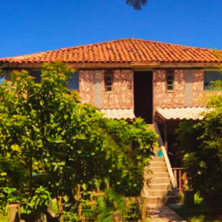 a house with a staircase leading up to it at Lua de Aquarius Boutique Hostel in Tamoios