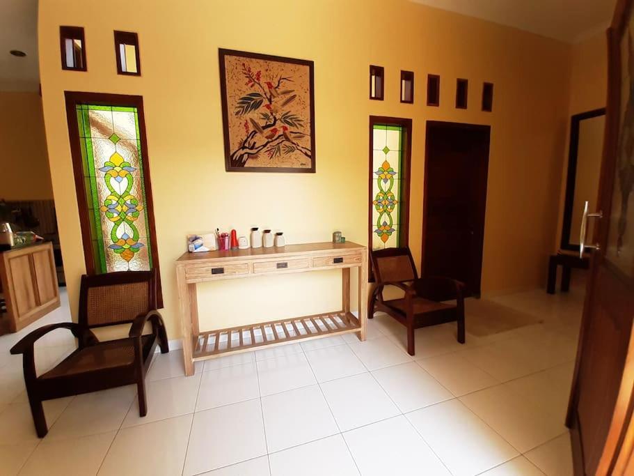 a room with a altar with two chairs and stained glass windows at Serasa Rumah in Yogyakarta