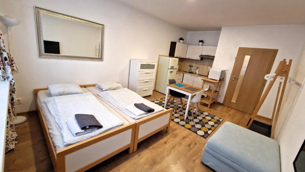 a small room with two beds and a kitchen at Prague city centre in Prague