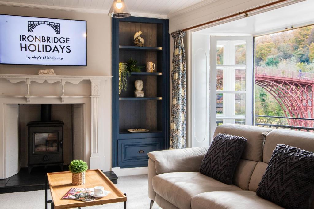 a living room with a couch and a fireplace at Number Six in Ironbridge