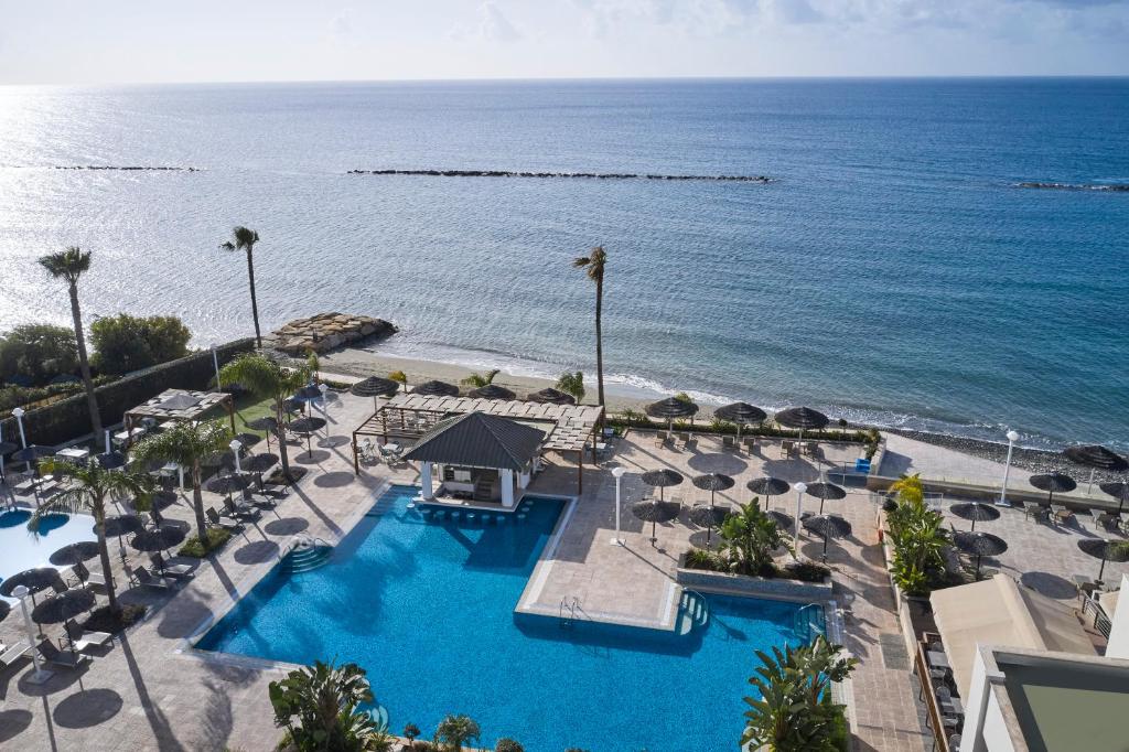 an aerial view of a resort with a pool and the ocean at Atlantica Miramare Beach in Limassol