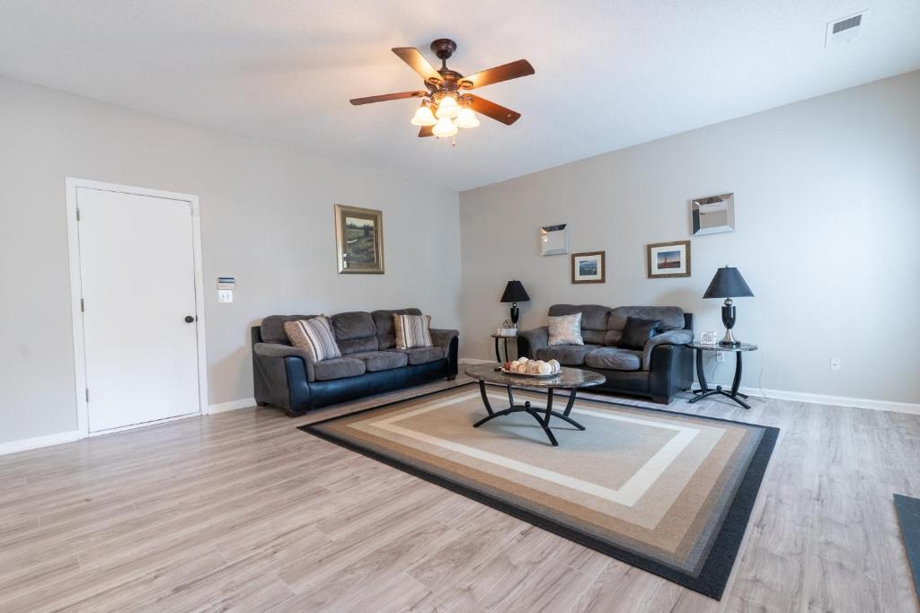 a living room with two couches and a ceiling fan at Charming Suburb 20 Min to ATL! in Decatur
