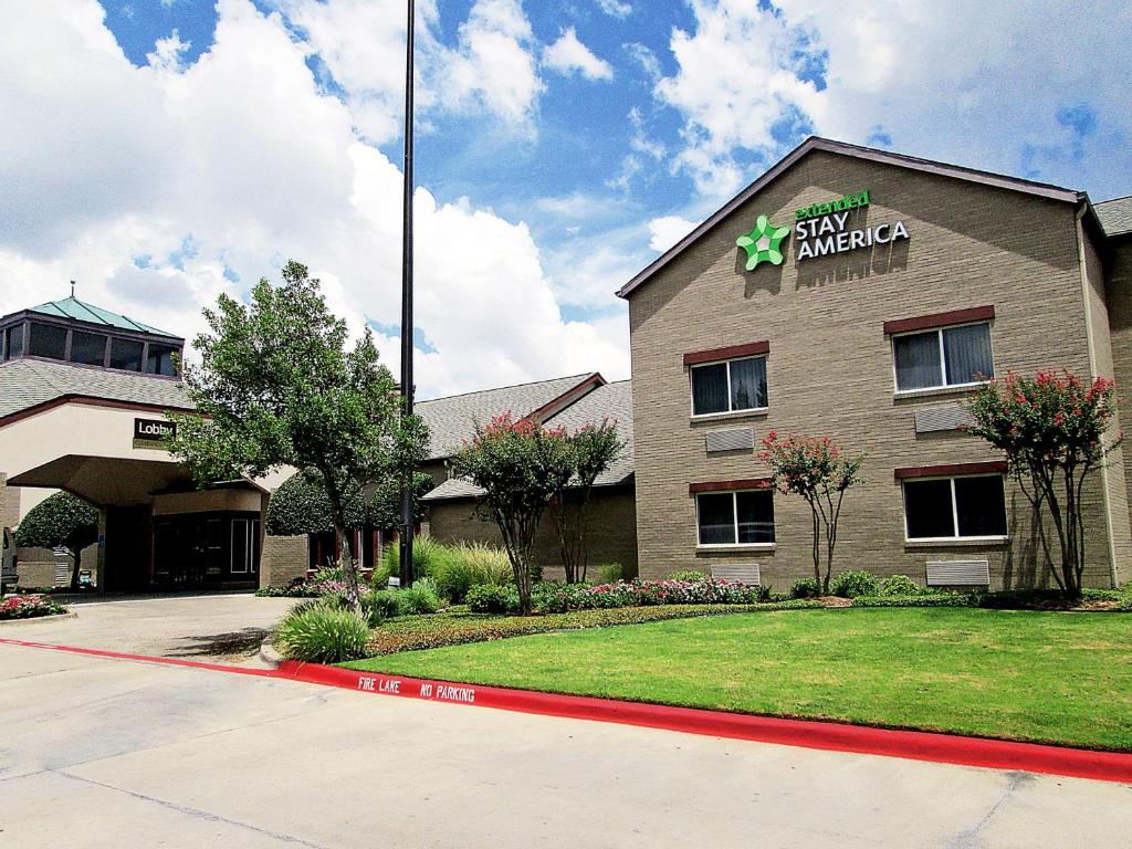 a building with a sign on the side of it at Extended Stay America Suites - Dallas - Richardson in Richardson