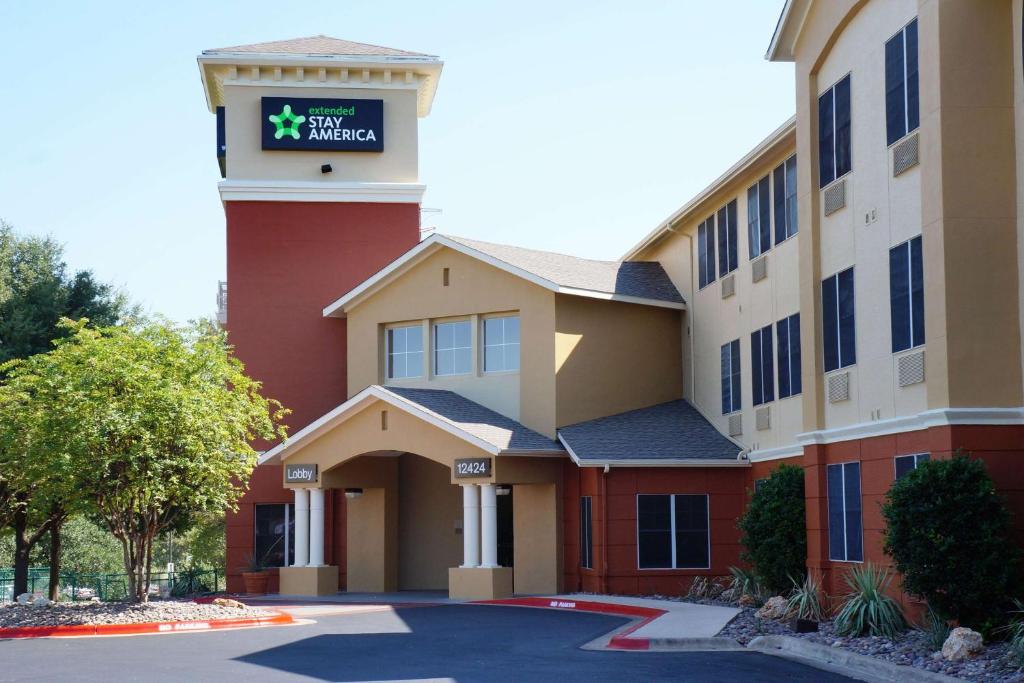 a hotel building with a sign on it at Extended Stay America Suites - Austin - Northwest - Research Park in Austin