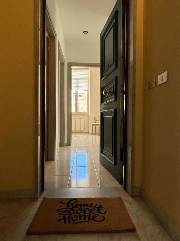a hallway with a door and a rug on the floor at Sweet home in Bordighera