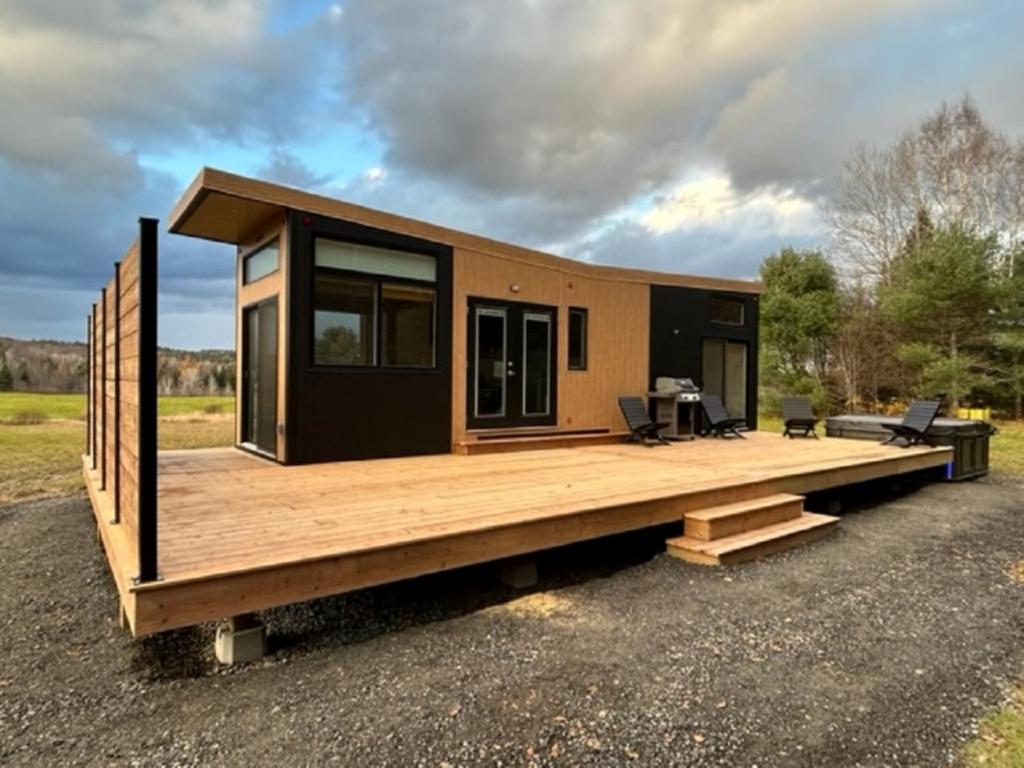 a modular home with a large wooden deck at Mini Muskoka Getaway - Huntsville in Huntsville