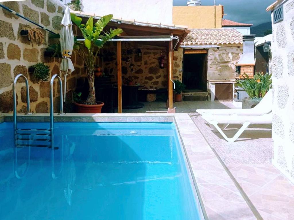 a swimming pool in front of a house at Live Arico Lagar in Arico el Nuevo
