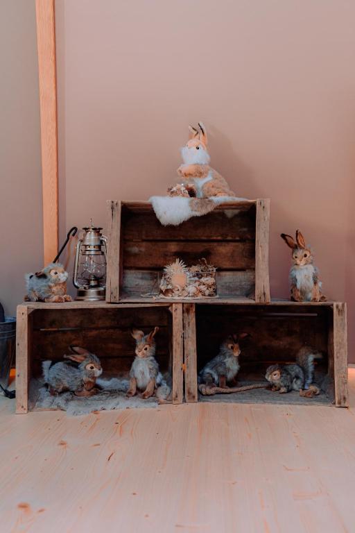 a group of stuffed animals sitting on a shelf at Altipik - Lodges Insolites in Mont-Saxonnex