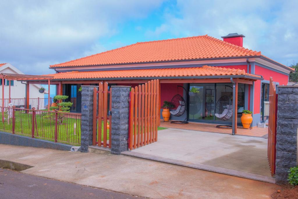 uma pequena casa com um telhado laranja em Villa Rosa em Porto Moniz