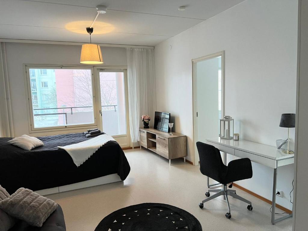 a bedroom with a bed and a desk and a deskablish at Star of Annala in Tampere