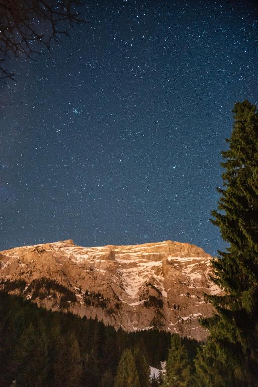 a mountain under a starry sky at night at Altipik - Lodges Insolites in Mont-Saxonnex