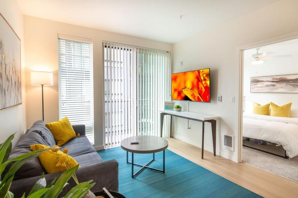 sala de estar con sofá, mesa y cama en Gymking Bed4k Smart Tvcable360 Rooftop Views, en Tacoma