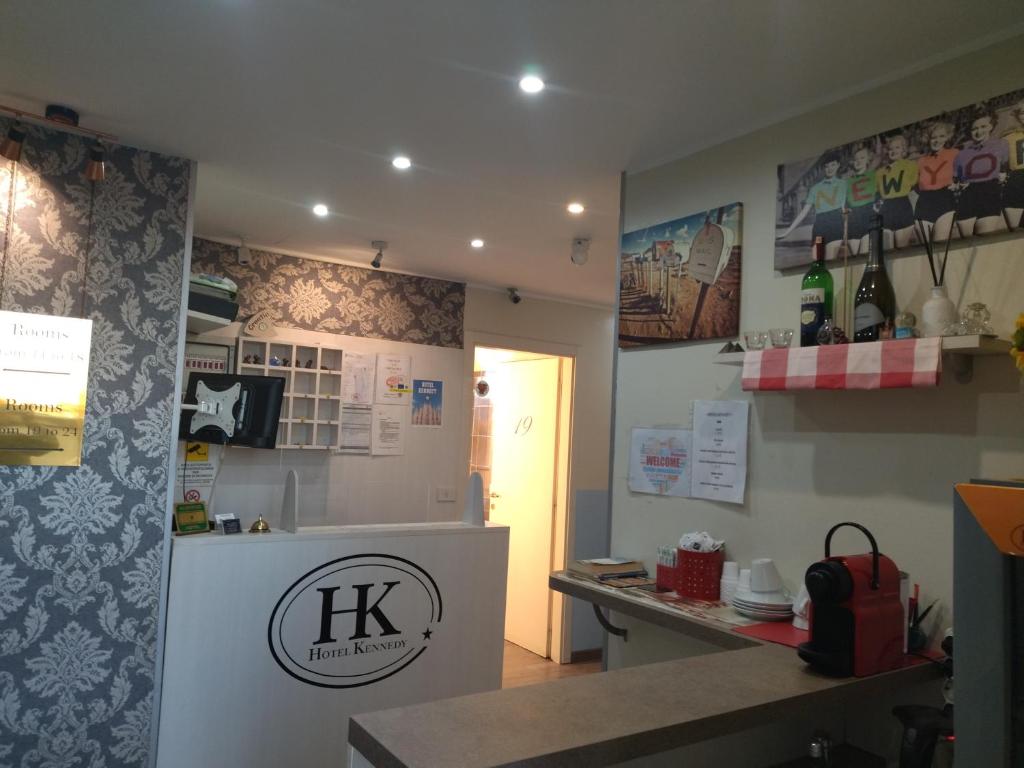 a kitchen with a refrigerator and a counter in a room at Hotel Kennedy in Milan