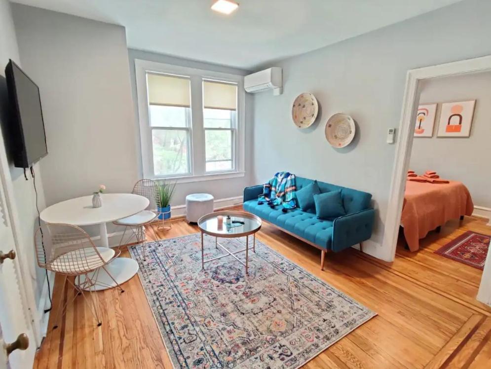 a living room with a blue couch and a bed at Cozy 1BDR In Center City Philly Hosted By StayRafa in Philadelphia