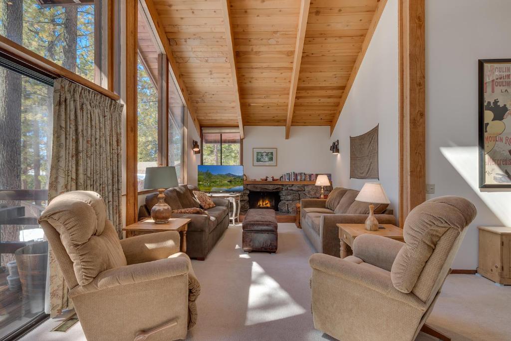 a living room with couches and a fireplace at Base Camp- Hot Tub, Large Deck, Wood Fireplace, Short Drive to Ski Resorts! in Tahoe City