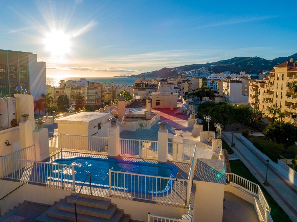a view of a city with a pool on a building at Apartamentos Solset Nerja in Nerja