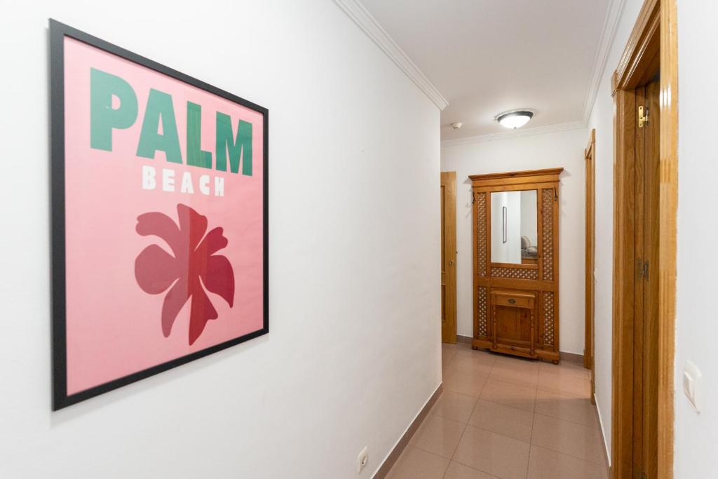 a hallway with a sign on a wall at Apartamentos Solset Nerja in Nerja