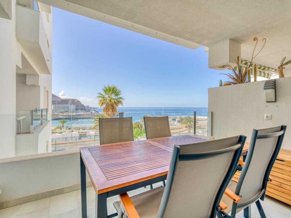 a dining room with a table and a view of the ocean at Haiti 306 vista al mar in Mogán