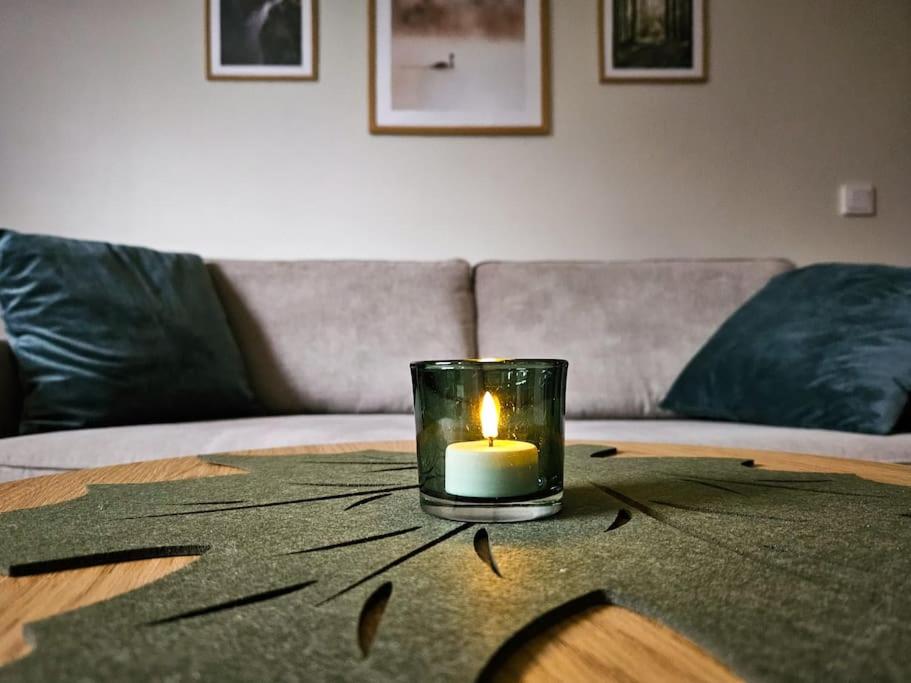 a candle sitting on top of a table at Arctic Halla's Studio in Rovaniemi