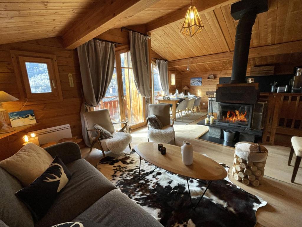 a living room with a couch and a fireplace at Appartement Saint-Martin-de-Belleville, 5 pièces, 8 personnes - FR-1-452-35 in Saint-Martin-de-Belleville