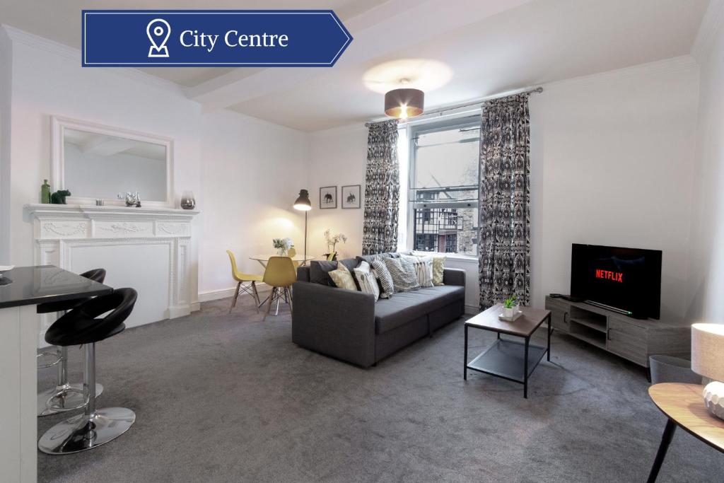 a living room with a couch and a tv at Chic Centrally Located 1 Bed Apt in Chester in Chester
