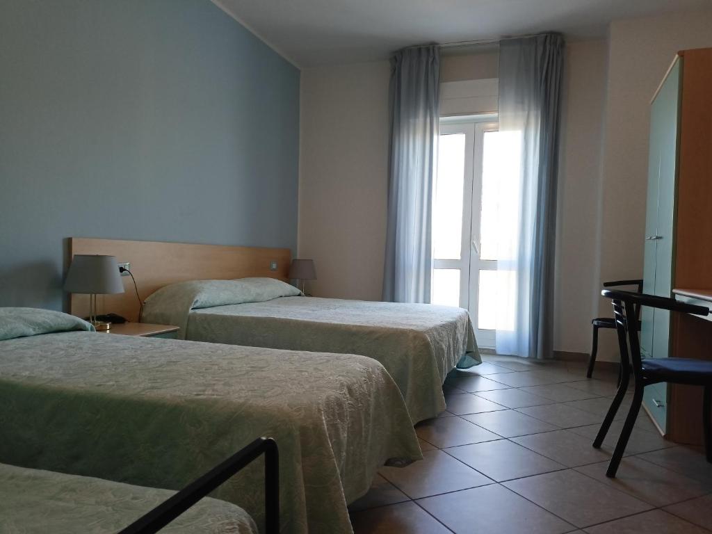 Postel nebo postele na pokoji v ubytování Hotel Ariston Imperial
