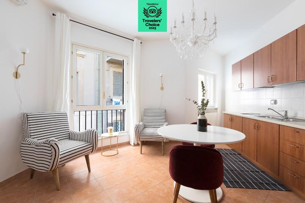 a kitchen with two chairs and a table and a table at Sonder Piazza San Pietro in Rome