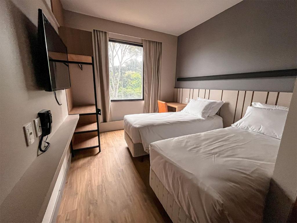 Postel nebo postele na pokoji v ubytování Plaza Hotel & Boulevard Convention - Vale dos Vinhedos