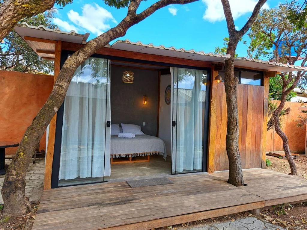 Schlafzimmer mit Glastüren und einem Bett auf einer Terrasse in der Unterkunft Casa Om - Vila de São Jorge in Sao Jorge