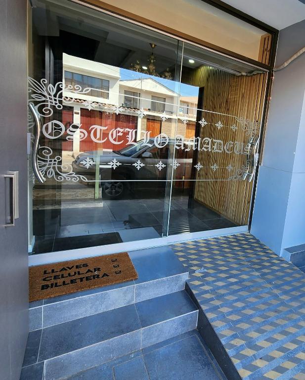 a entrance to a store with a sign in the window at Hostal Ostello Amadeus in Arica